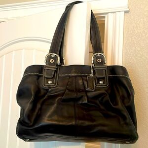 Black leather coach bag with buckle details